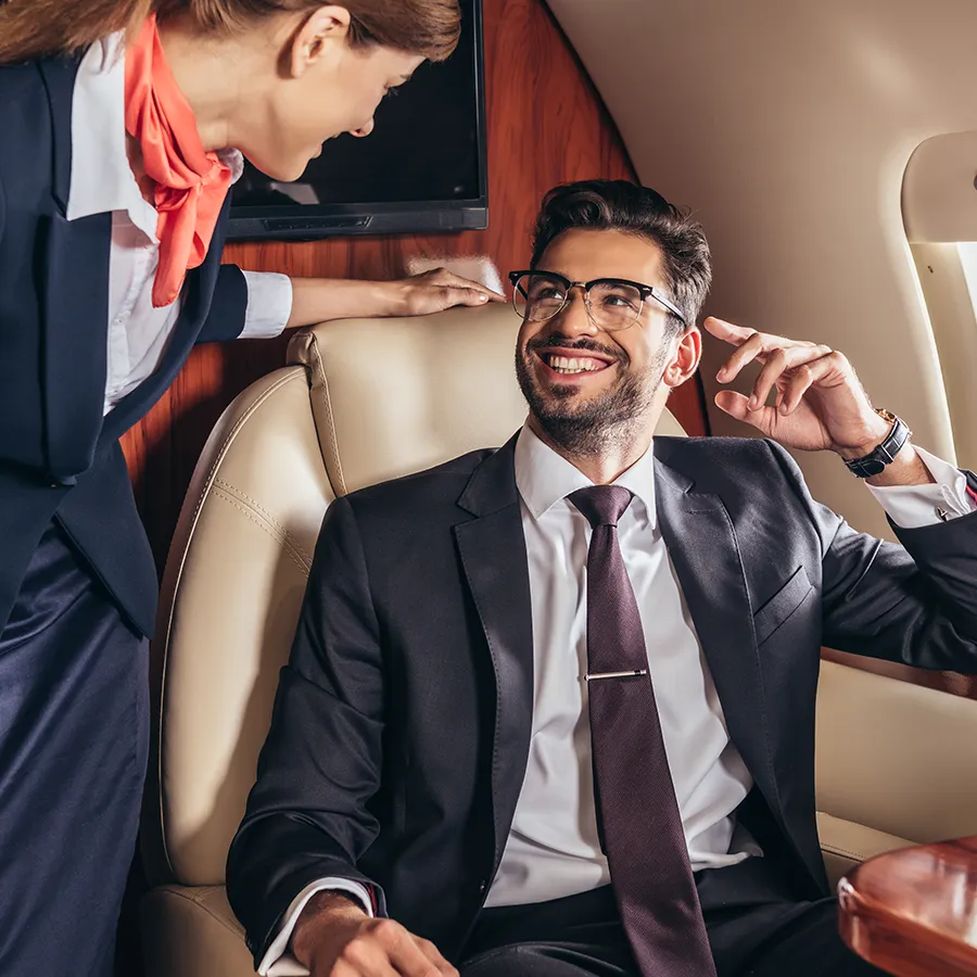 An elegant man sitting inside a private jet