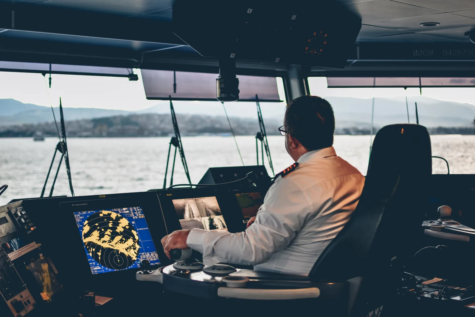 Captain at the helm of a yacht under way